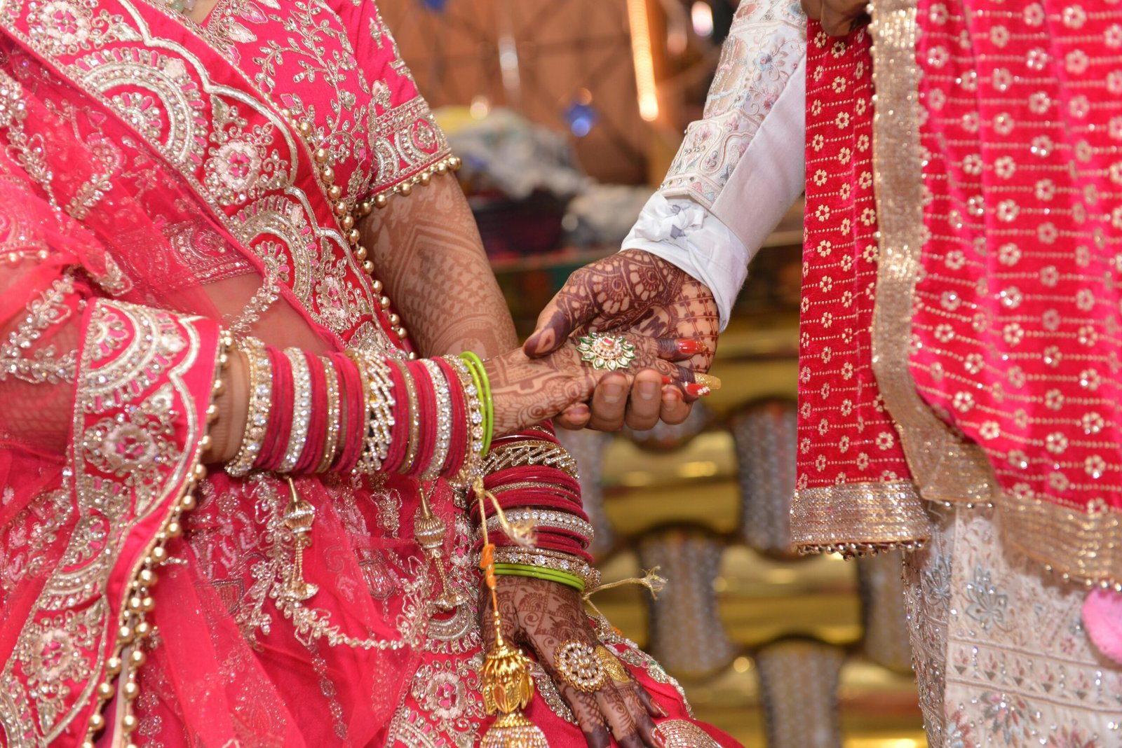 About Close-up of a colorful Indian wedding ceremony featuring intricate henna designs and traditional attire.